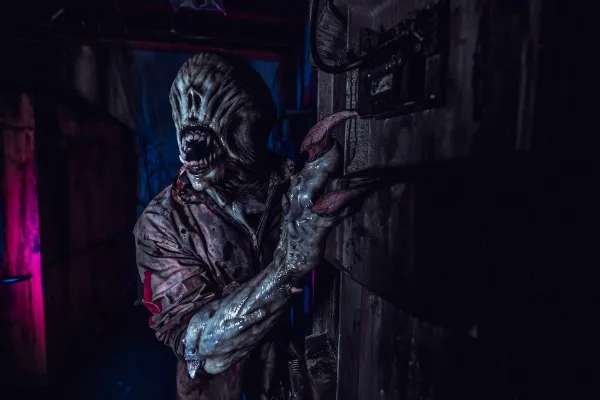Monster character lurking in a haunted house environment.